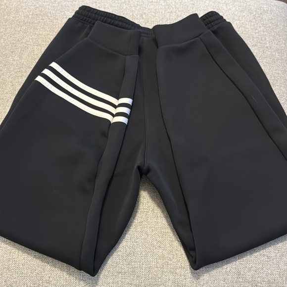 Adidas black joggers with zipper pockets and 3 stripes on bottom of one leg - Picture 2 of 4